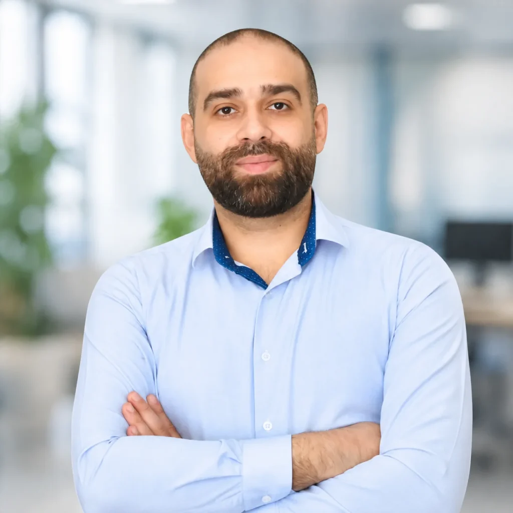 Waseem Hartak, CEO of Pacific Digital, smiling with arms crossed in an office